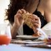 Woman enjoying breakfast with croissant and juice in Calabria, Italy.