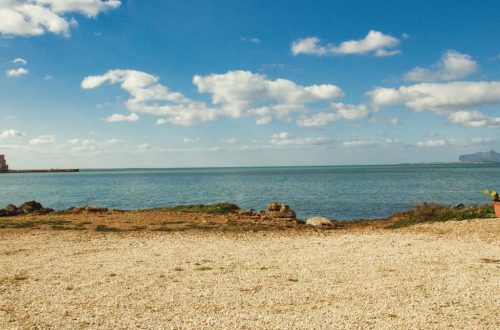 Tranquil view of the coastline in Trapani, Sicily with clear blue sky and sea.